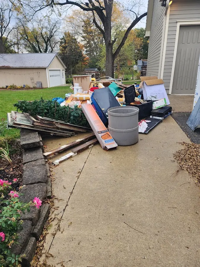 Dumpster being loaded with debris for Estate Cleanout Dumpster Rental in Jonesboro